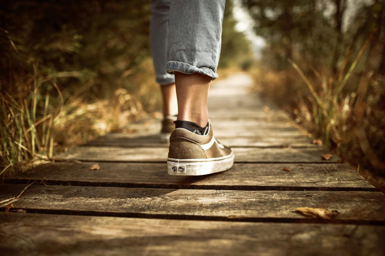 A person walking on a scenic trail, showcasing the physical benefits of walking for weight loss and